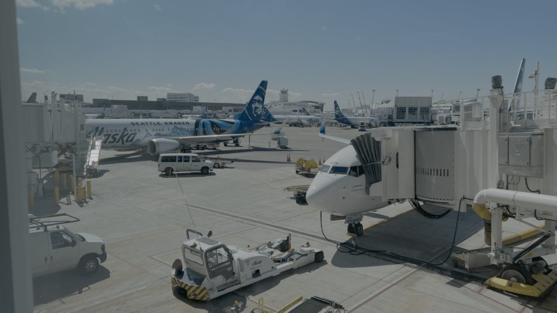 Airplanes at airport gate during ground operations amid FAA flight disruptions