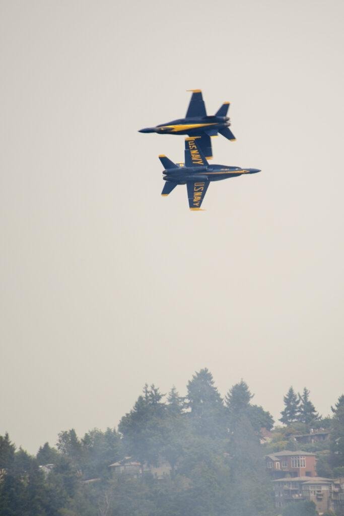 Two U.S. Navy Blue Angels aircraft perform an opposing pass during the 2017 Boeing Seafair Air Show over Seattle.