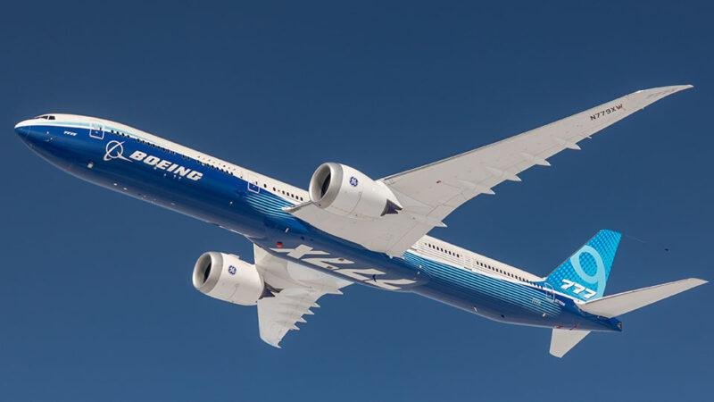 Boeing 777-9 banking in flight, showing folding wingtips and registration N779XW