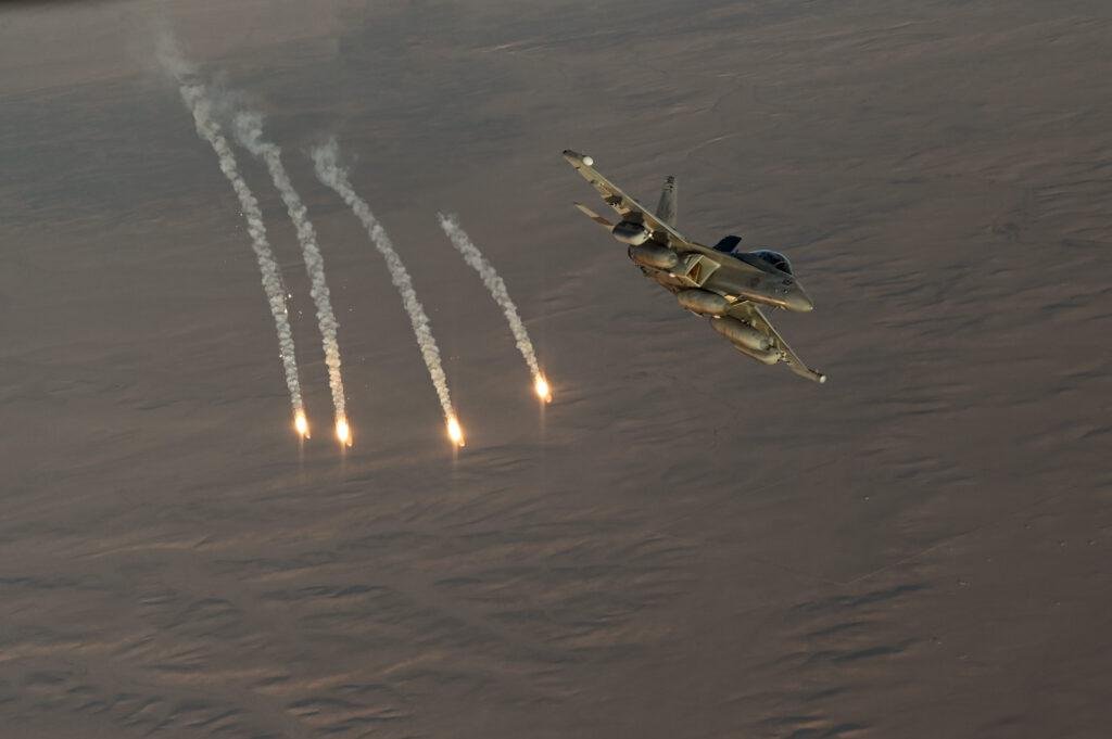 EA-18G Growler dispensing flares over water, 20 years after the EA-18G Growler first flight