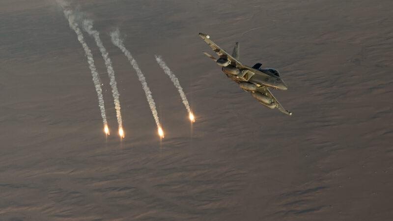 EA-18G Growler dispensing flares over water, 20 years after the EA-18G Growler first flight