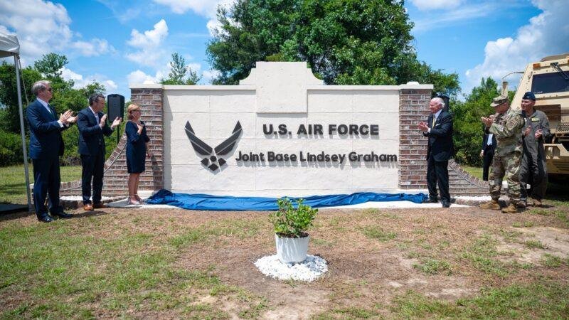Officials unveil the new Joint Base Lindsey Graham sign during the renaming ceremony in South Carolina.