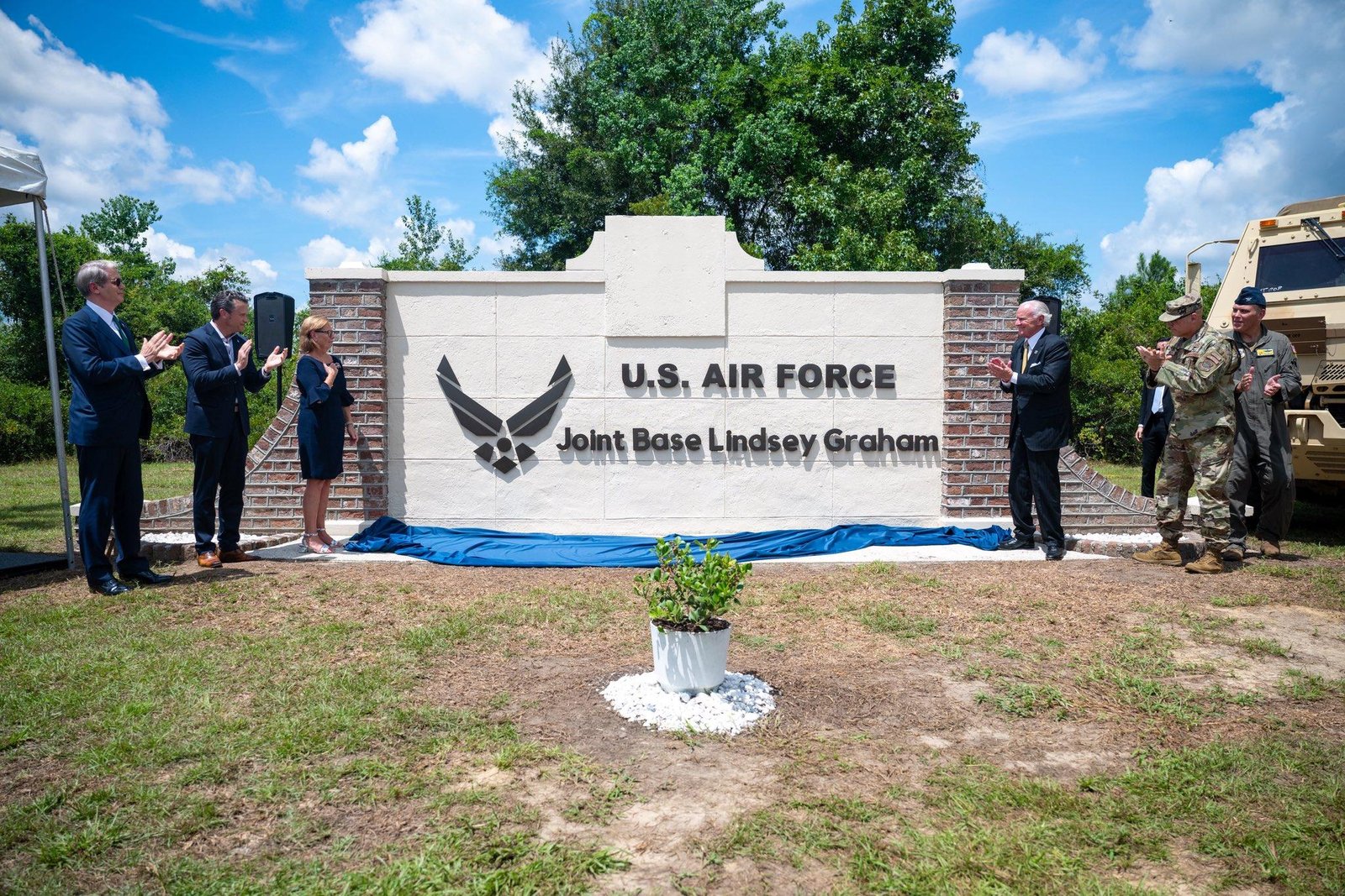 Officials unveil the new Joint Base Lindsey Graham sign during the renaming ceremony in South Carolina.