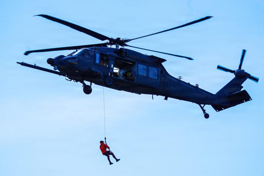 HH-60W Jolly Green II of the 210th Rescue Squadron, Alaska Air National Guard, conducts a hoist demonstration at Arctic Thunder Open House