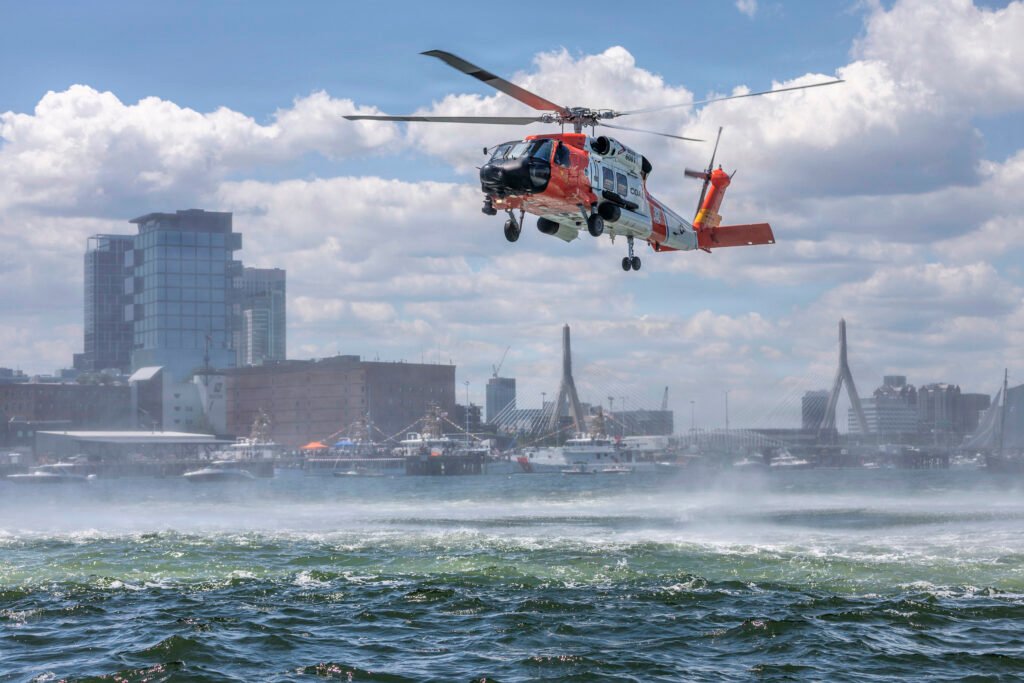 U.S. Coast Guard 236th Birthday feature image showing a Coast Guard helicopter conducting a maritime flight over Boston Harbor.