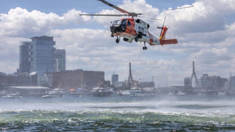 U.S. Coast Guard 236th Birthday feature image showing a Coast Guard helicopter conducting a maritime flight over Boston Harbor.