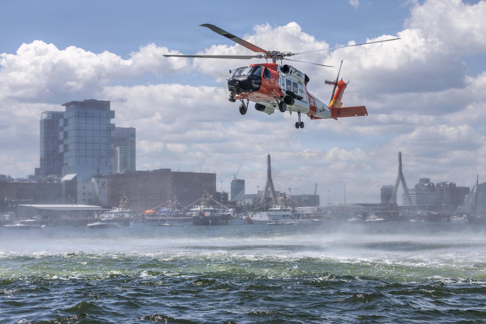 U.S. Coast Guard 236th Birthday feature image showing a Coast Guard helicopter conducting a maritime flight over Boston Harbor.