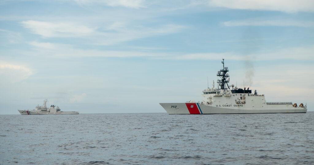 A U.S. Coast Guard cutter operates alongside a Philippine Coast Guard vessel during a joint maritime mission.