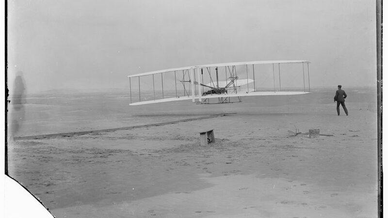 Orville Wright pilots the Wright Flyer during the first powered flight at Kitty Hawk on December 17, 1903