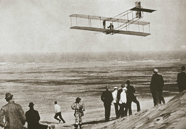 The Wright Flyer airborne during the fourth and longest flight of December 17, 1903, at Kitty Hawk, North Carolina