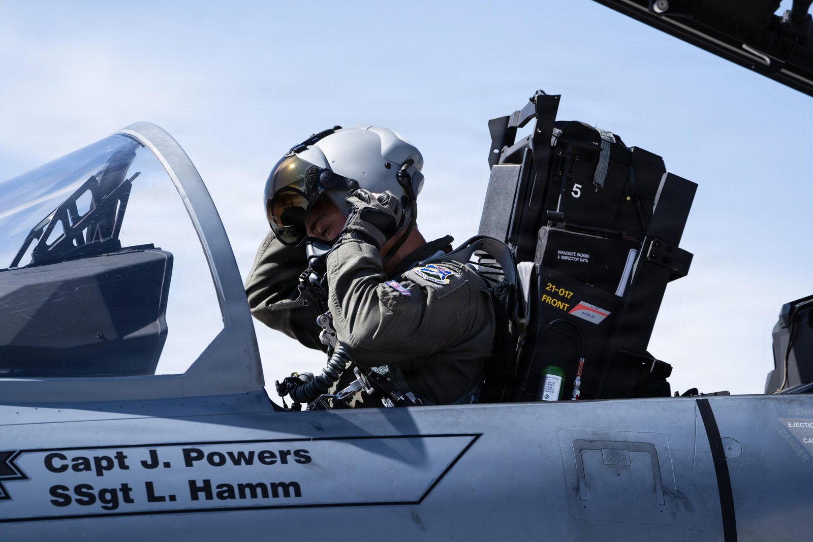 Oregon Air National Guard F-15EX Eagle II pilot dons flight gear in the cockpit ahead of a live-bomb training sortie at Nellis Air Force Base