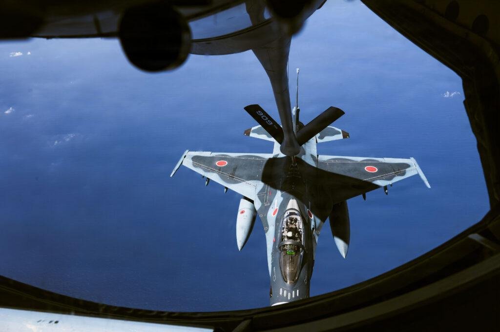 U.S. Air Force KC-46A Pegasus tanker flying in formation with Japan Air Self-Defense Force F-2 fighters over the Pacific Ocean
