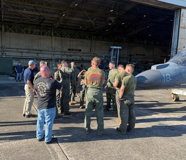 Marines and Naval Air Systems Command personnel gather around the last USMC-built AV-8B Harrier II at MCAS Cherry Point before its move to museum display