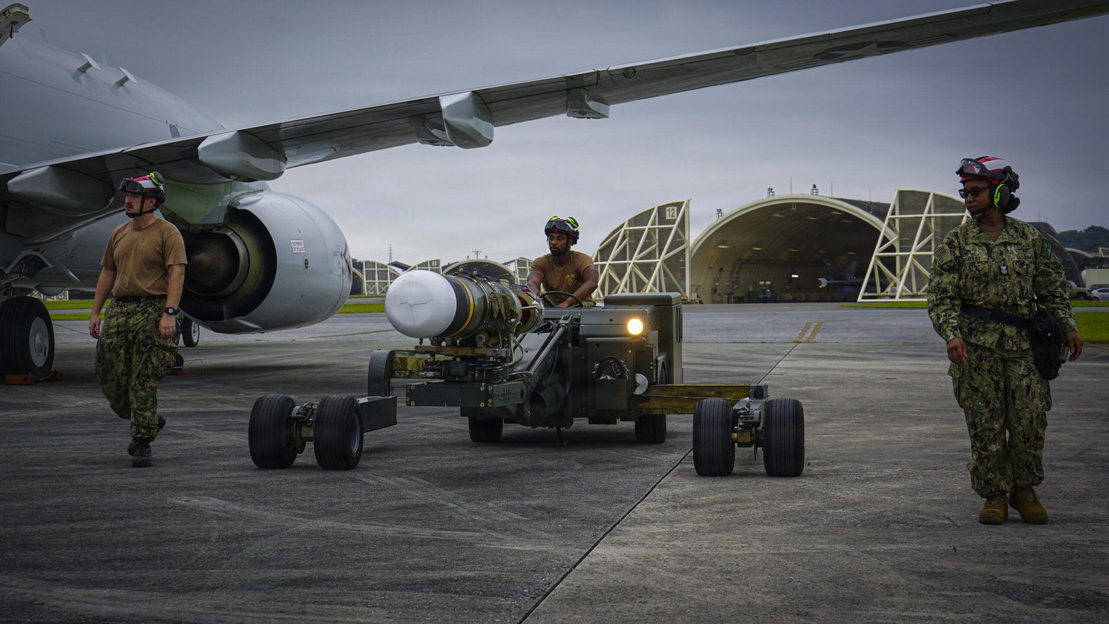 Sailors load a Mk 54 lightweight torpedo onto a P-8A Poseidon at Kadena Air Base