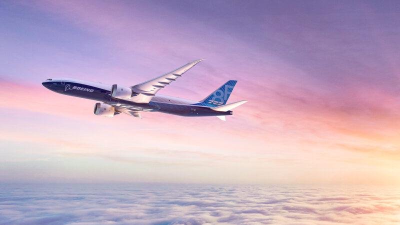 Boeing 777-8 Freighter flying above clouds at sunset