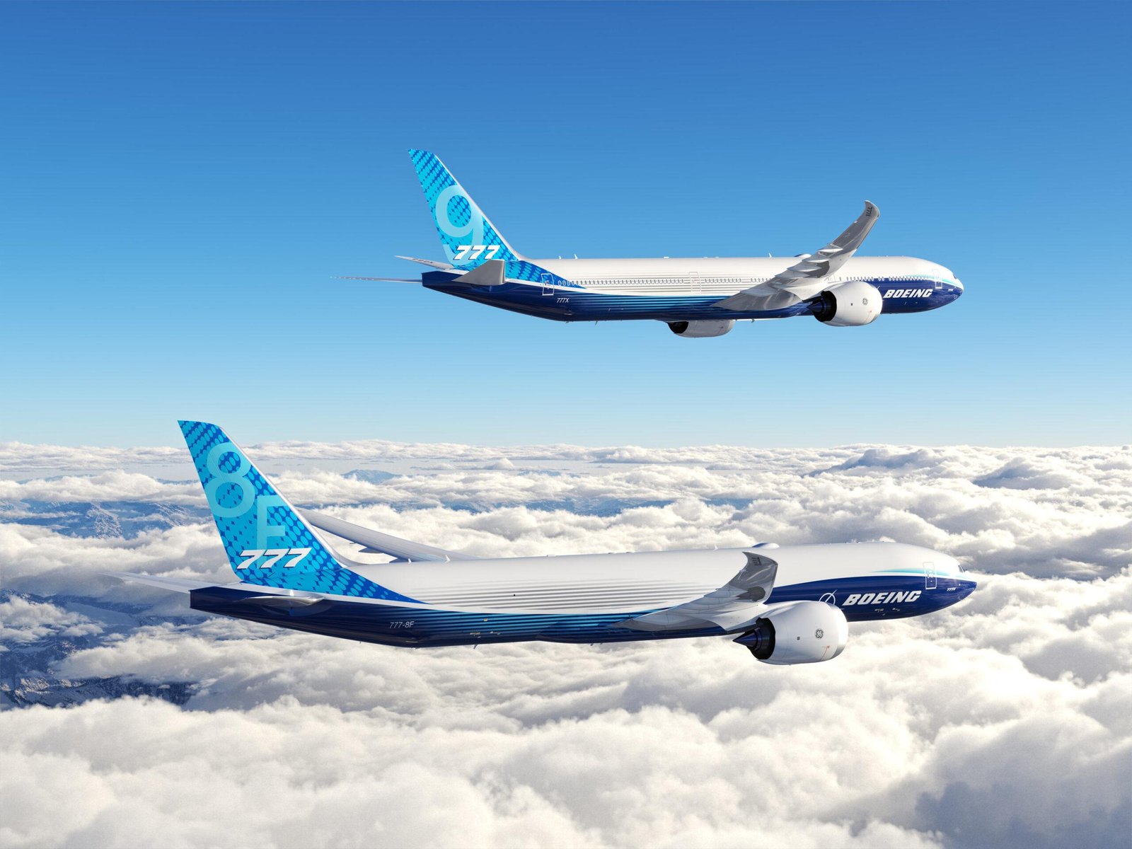 Boeing 777-8 Freighter and 777-9 passenger aircraft flying above clouds