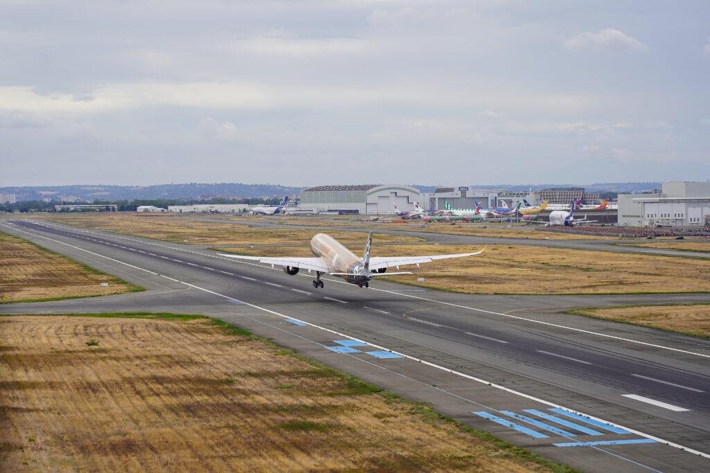 A350F first flight: the Airbus freighter coming in to land over a runway at Toulouse, seen from a helicopter