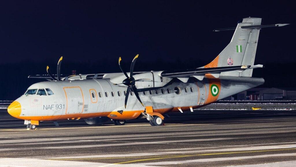 Nigerian Air Force ATR-42-500MP serial NAF 931 parked at night with an orange nose and the Nigerian flag on the tail