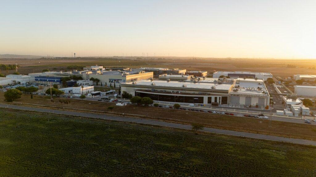 Airbus Cadiz plant aerial view showing the expanded aerospace manufacturing facility in El Puerto de Santa María, Spain, at sunset.
