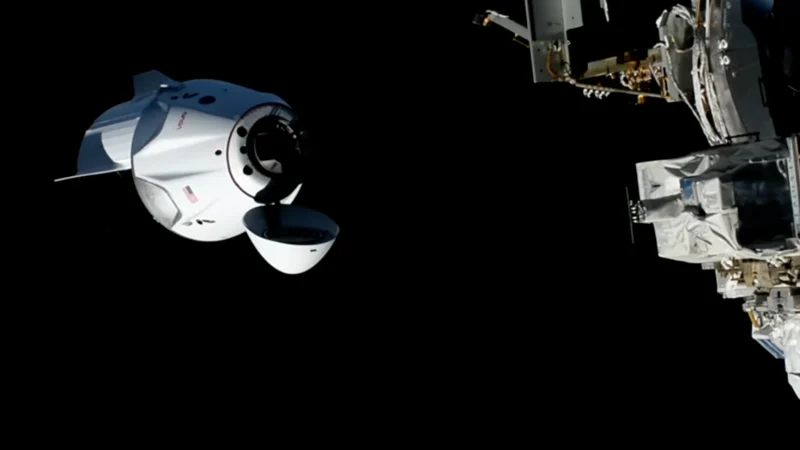 SpaceX Crew-13 Dragon spacecraft with its nose cone open approaching the International Space Station