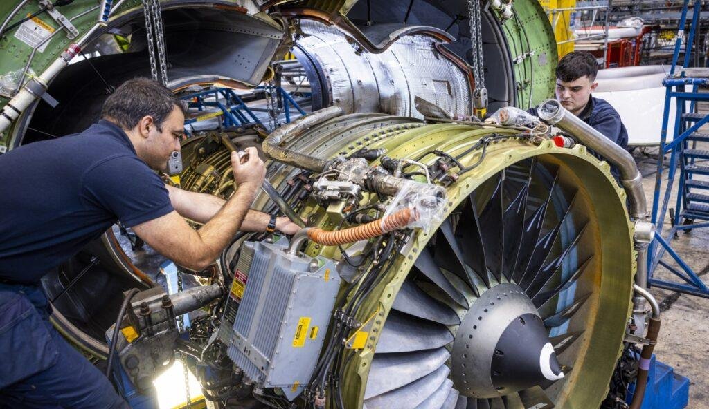 Dublin Aerospace Agreement illustrated by two aircraft maintenance technicians working on a disassembled jet engine.