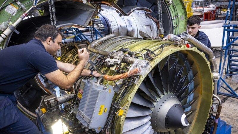 Dublin Aerospace Agreement illustrated by two aircraft maintenance technicians working on a disassembled jet engine.