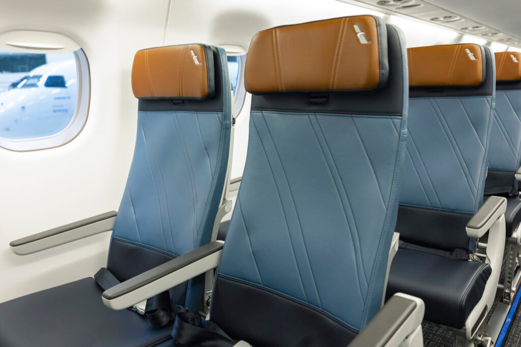 Embraer E175 Seats featuring blue upholstery and tan RECARO headrests in the new American Eagle regional jet cabin.