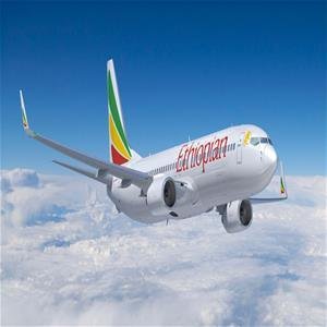 Ethiopian Airlines passenger jet flying above clouds in the airline's green, yellow and red livery.