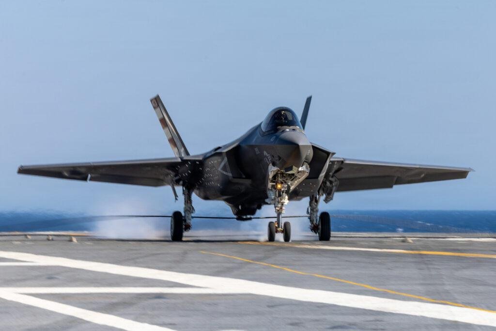 F-35C Kennedy landing showing a U.S. Navy F-35C Lightning II touching down on the aircraft carrier's flight deck.