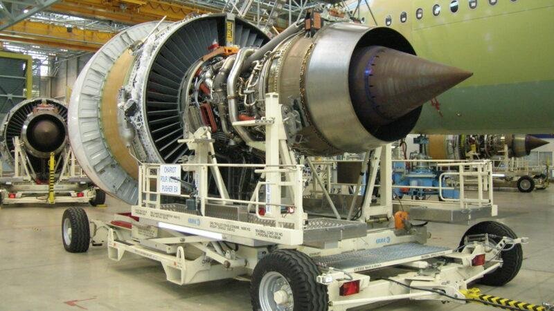 An uncowled Engine Alliance GP7200 turbofan on a wheeled transport cart inside an aircraft hangar, illustrating the FAA A380 engine seal directive.