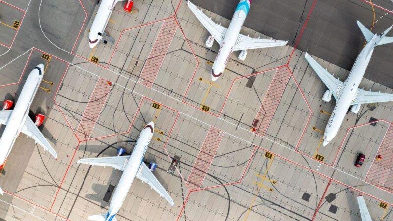 FL Technics UAE approvals illustrated by an aerial view of commercial aircraft parked at airport maintenance stands.