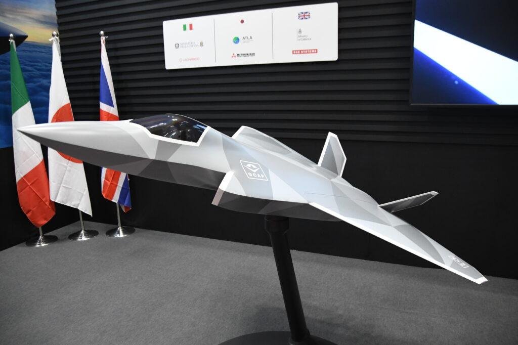 Germany GCAP talks illustrated by a next-generation fighter concept model displayed alongside the flags of Britain, Italy and Japan.