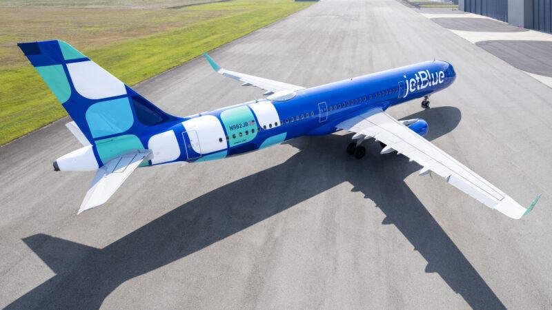 JetBlue Cali Flights illustrated by a JetBlue Airbus A321 aircraft in blue-and-turquoise Mint livery parked on an airport apron.