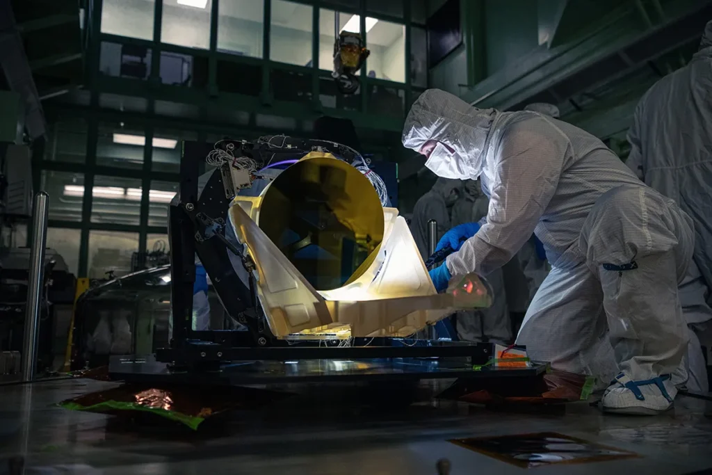 LISA test telescope prototype undergoing inspection by a NASA technician inside a clean room at Goddard Space Flight Center.