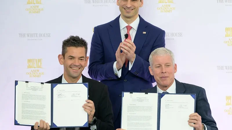 NASA nuclear power pact signing showing NASA Administrator Jared Isaacman and Energy Secretary Chris Wright holding their signed space nuclear cooperation agreement.