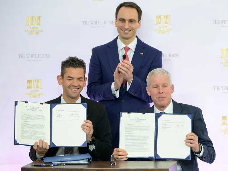NASA nuclear power pact signing showing NASA Administrator Jared Isaacman and Energy Secretary Chris Wright holding their signed space nuclear cooperation agreement.