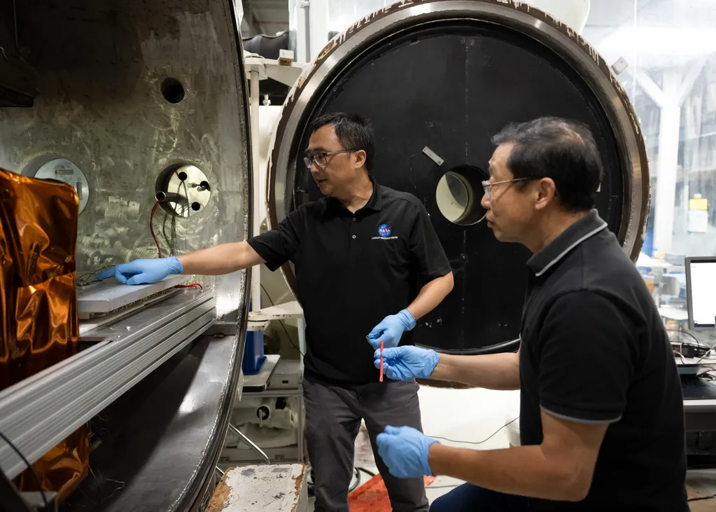 NASA SPEARS batteries researchers Yi Lin and Ji Su handle prototype cells during thermal-vacuum testing at NASA Langley