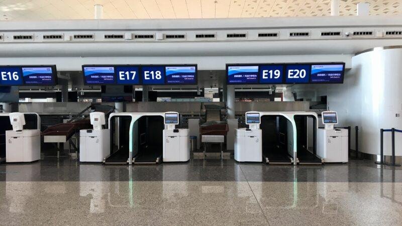 SITA Collins deal illustrated by airport self-service check-in and baggage-drop kiosks at Wuhan Tianhe International Airport.