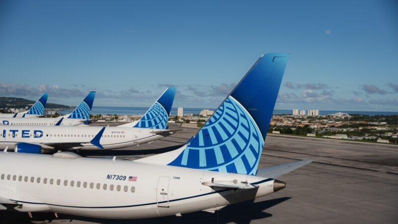 United Airlines Boeing 737 MAX 8 aircraft parked at an airport in Guam, illustrating United Guam Starlink Wi-Fi installations.
