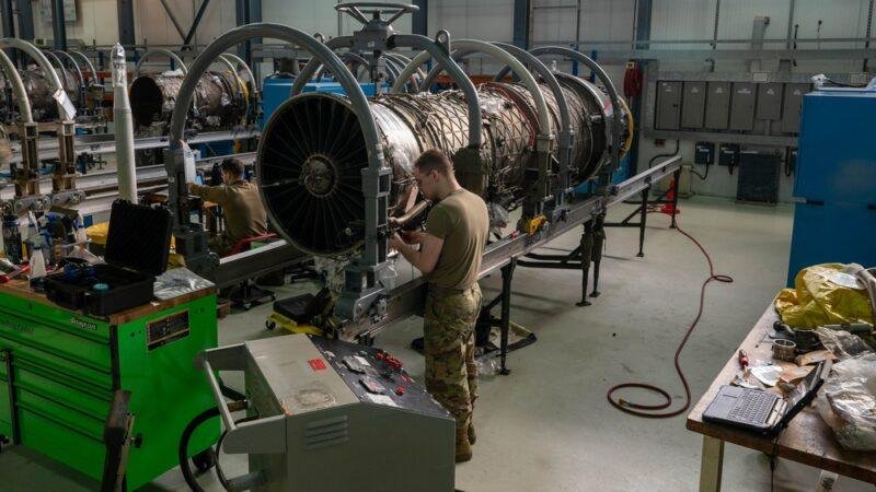 U.S. Air Force aerospace propulsion specialist works on an F100-PW-220 jet engine at RAF Lakenheath in February 2024.