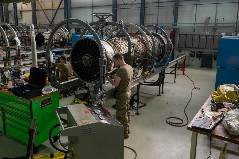 U.S. Air Force aerospace propulsion specialist works on an F100-PW-220 jet engine at RAF Lakenheath in February 2024.